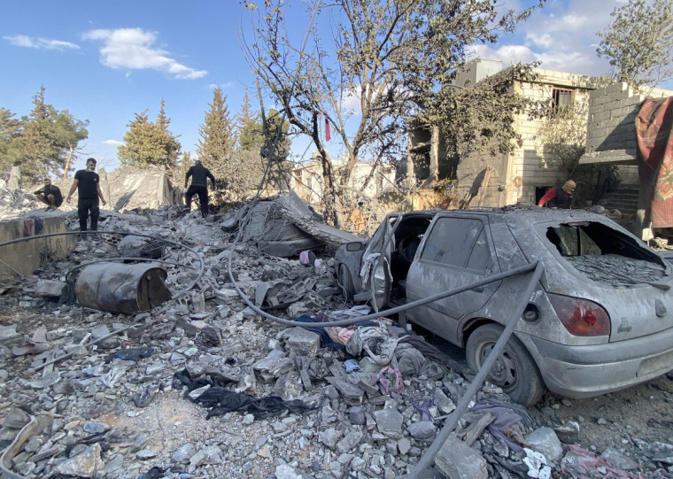  People check the destruction at the site of an Israeli airstrike that targeted the eastern village of Bazzaliyeh in the Hermel district of Lebanon's Bekaa valley, near the border with Syria, on November 1, 2024, amid the ongoing war between Israel and Hezbollah. (Photo by Sam SKAINEH / AFP)